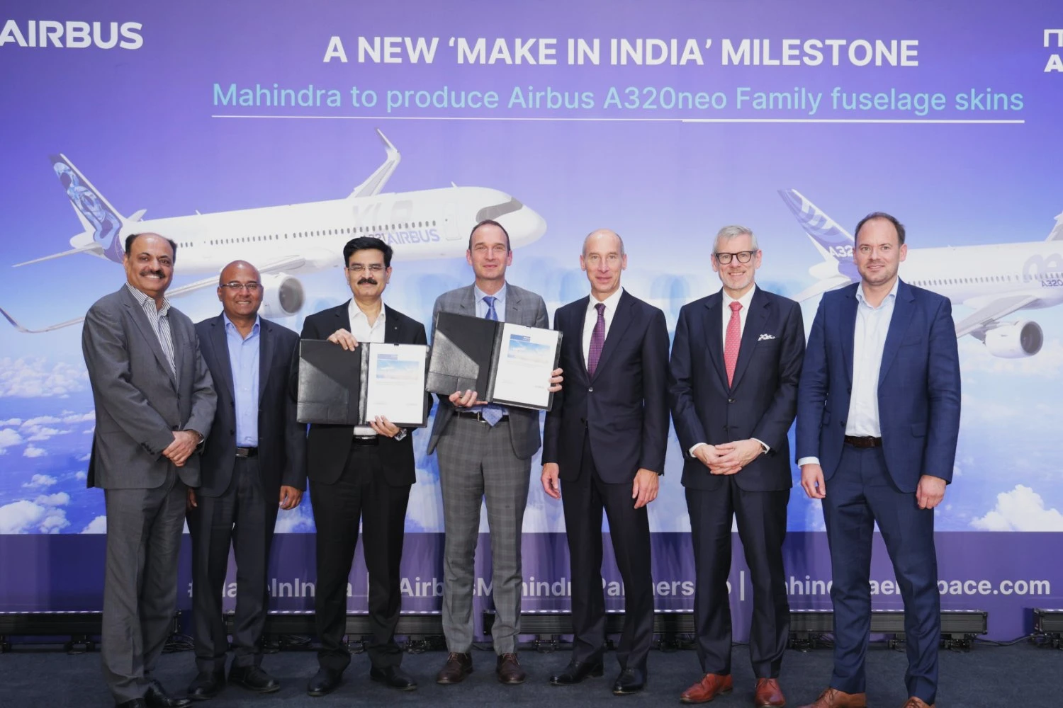 Executives from Airbus and Mahindra Aerostructures present the newly signed contract for A320neo family fuselage skin production in India