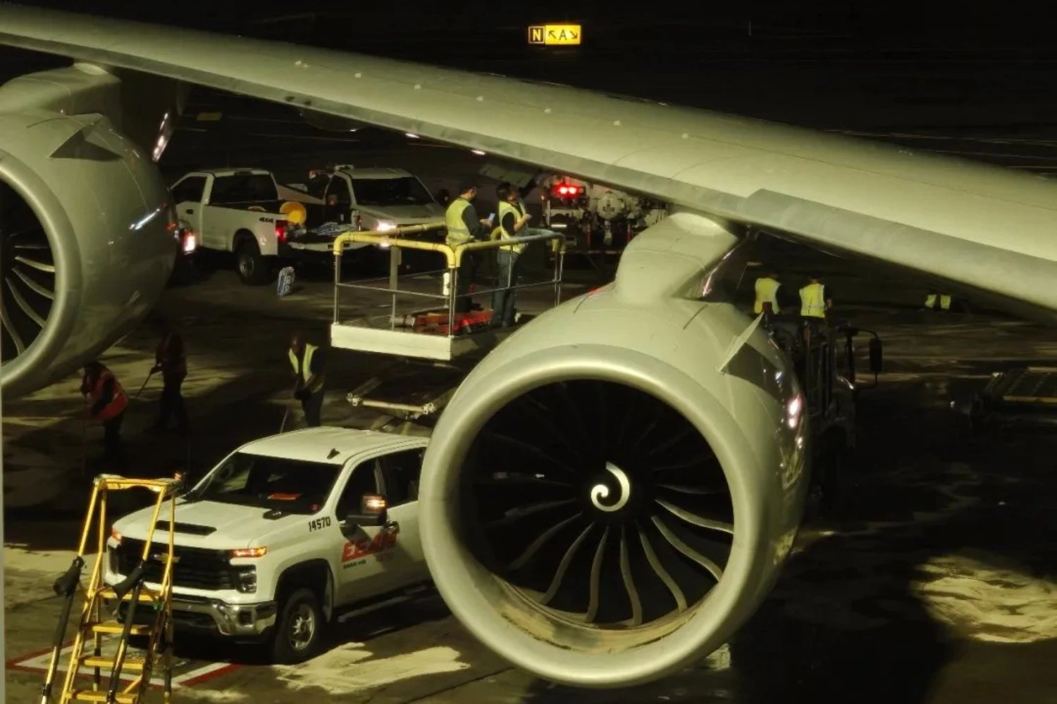 Workers operate beneath the wing of an Air China Boeing 747-8.